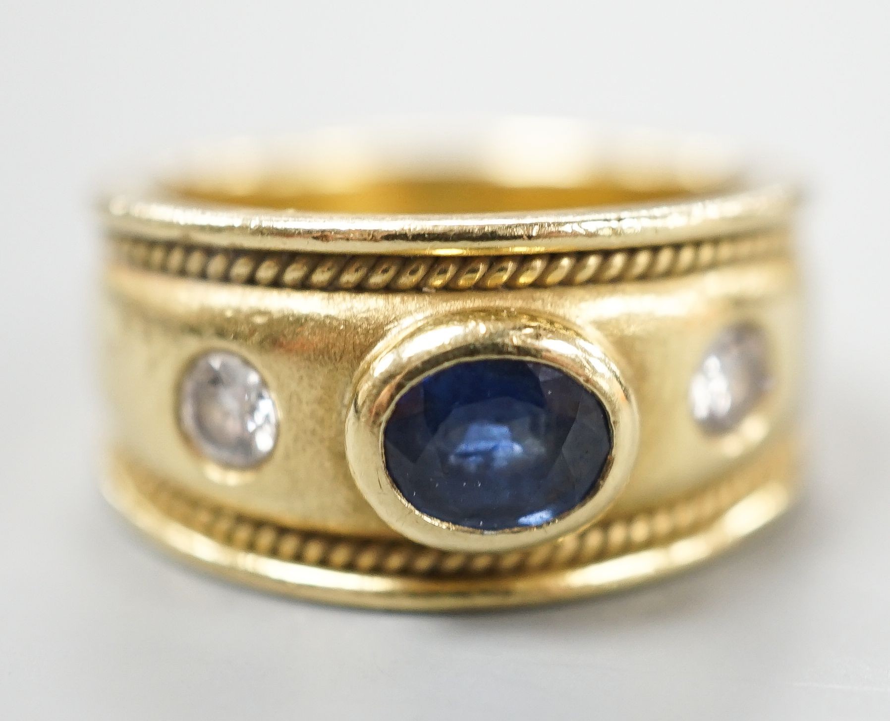 A modern yellow metal and collet set sapphire and diamond three stone ring, signed Charles Greig, size M, gross weight 11.5 grams.